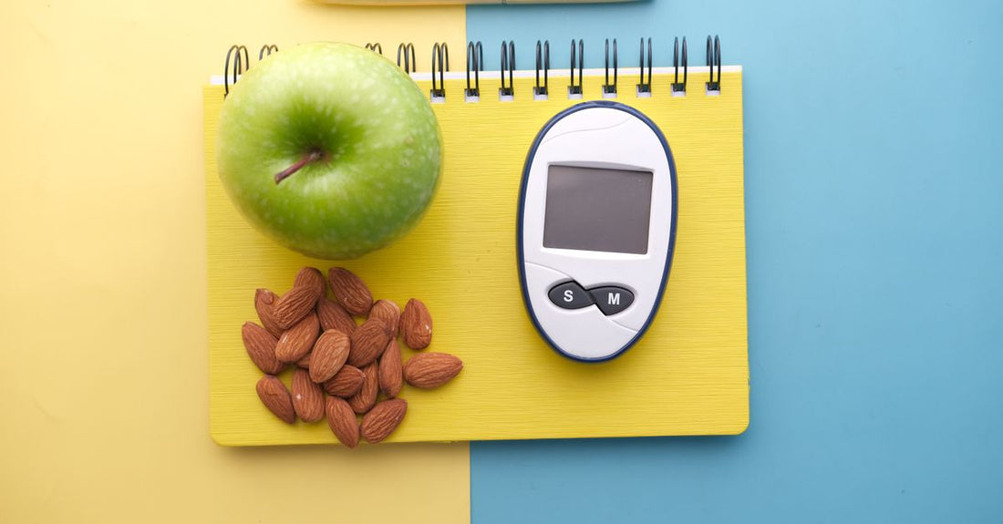 A flatlay of a glucose monitor, supplement capsules and healthy snacks, representing how to fix low blood sugar naturally.