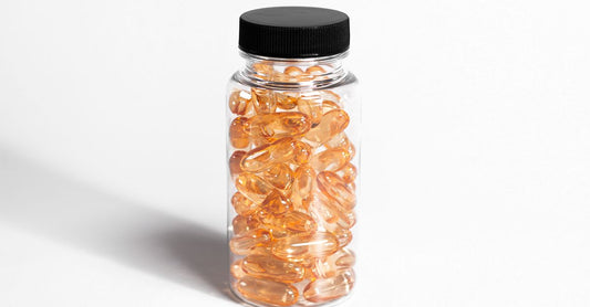 Bottle of omega 3 fish oil for dogs dosage guide next to a measuring spoon on a light background, showing transparent golden oil.