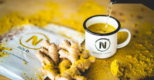 Bowl of maca root powder with wooden spoon