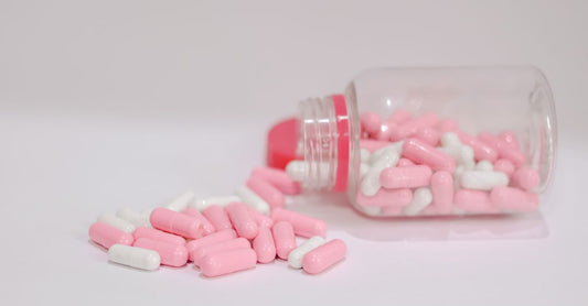 Bottle of L-theanine capsules beside a dopamine and serotonin molecular structure diagram, illustrating how to increase serotonin and dopamine naturally.