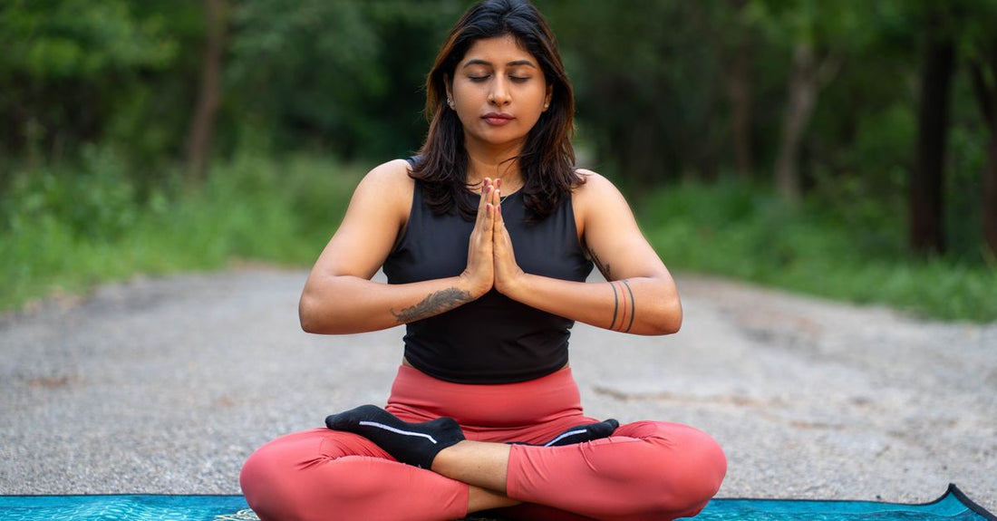 A yoga mat and cushion set up for a pranayama breathing session to practice pranayama for stress relief at home.
