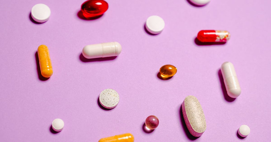 Assorted multivitamin capsules and mineral supplements arranged on a clean surface, representing a multivitamin for teenage girls with minerals.