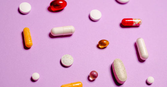 Assorted multivitamin capsules and mineral supplements arranged on a clean surface, representing a multivitamin for teenage girls with minerals.