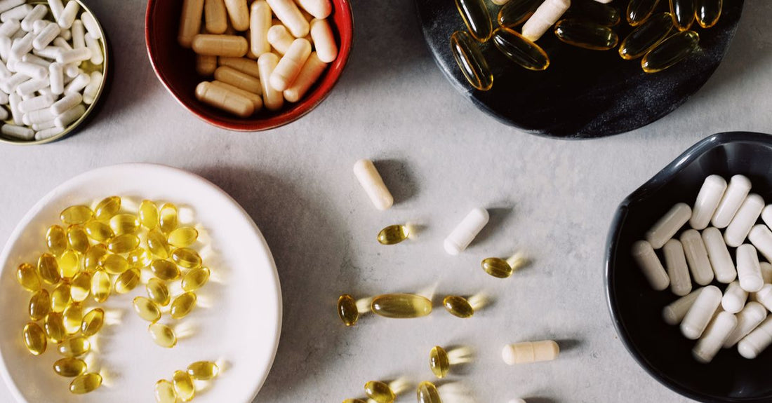 A selection of whole food multivitamin capsules and a bottle on a light background, representing the best whole food multivitamin for women 50+.