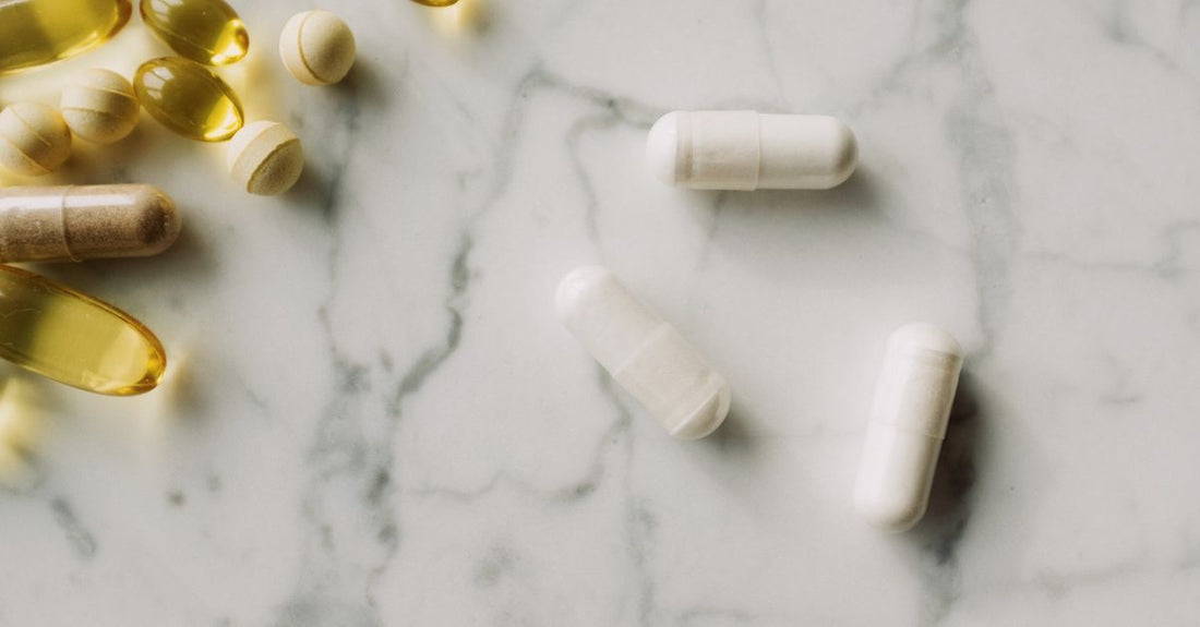 A sciatic soothe supplement bottle and capsules on a clean white surface, representing nerve health support