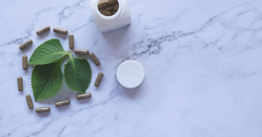 A bottle of green propolis capsules on a clean white surface, highlighting green propolis benefits for immune system support.