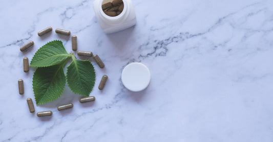 A bottle of green propolis capsules on a clean white surface, highlighting green propolis benefits for immune system support.