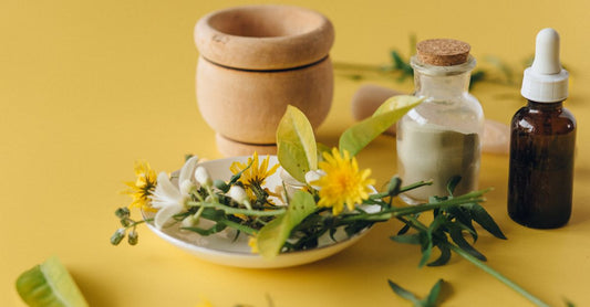Glass jar of saffron extract capsules beside dried saffron threads on a wooden surface, representing saffron extract for mood support.