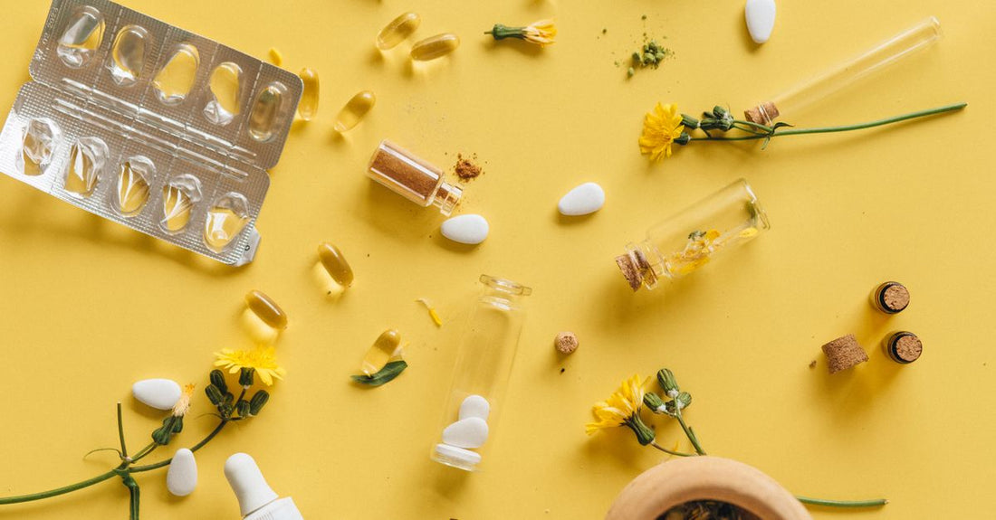 Bottle of saffron extract capsules for PMS relief on a white background, with dried saffron strands scattered around.