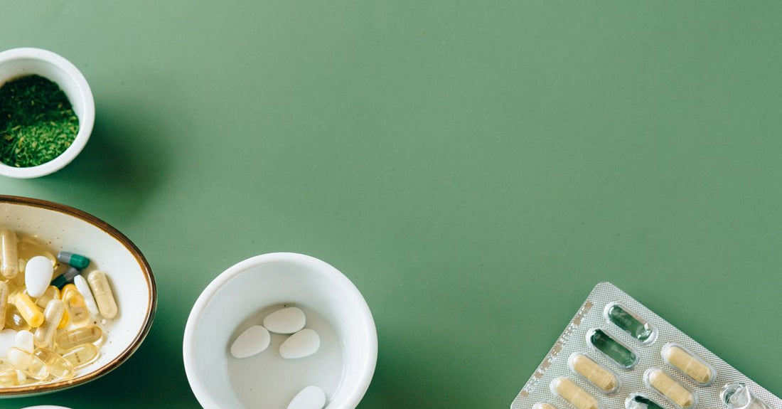 A flatlay of various vitamin and herbal supplement bottles arranged on a light surface, representing the complete guide to vitamins herbs supplements review.