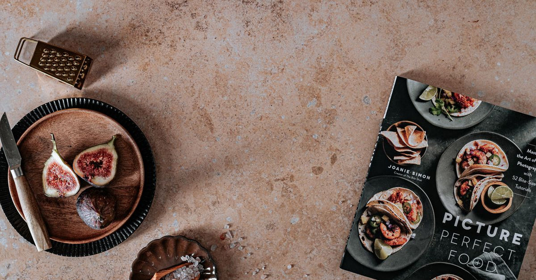 The Doctor's Kitchen healthy recipes book open on a kitchen counter surrounded by fresh vegetables and ingredients, illustrating its science-backed approach to nutrition.