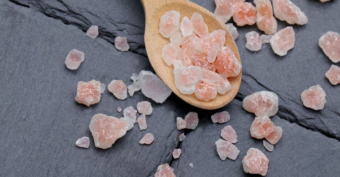 Bottle of Himalayan salt capsules on a clean white surface, showcasing the natural pink mineral supplement for daily electrolyte balance.