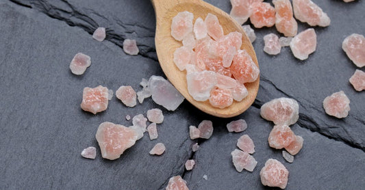 Bottle of Himalayan salt capsules on a clean white surface, showcasing the natural pink mineral supplement for daily electrolyte balance.